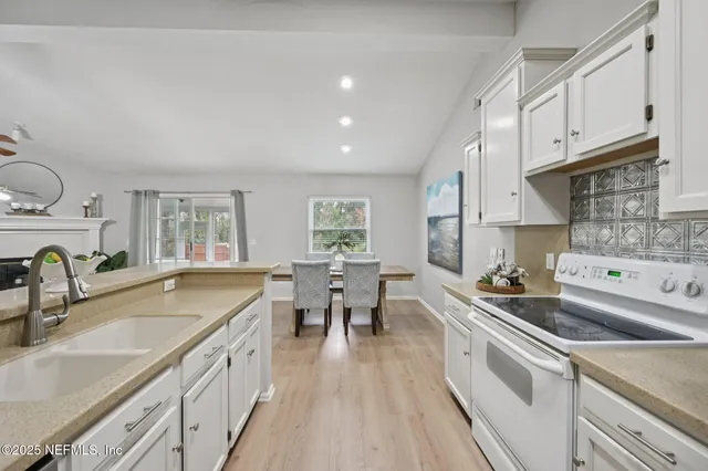 a kitchen with a sink stove and cabinets