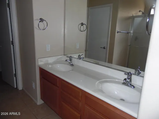 a bathroom with double vanity sink and a mirror