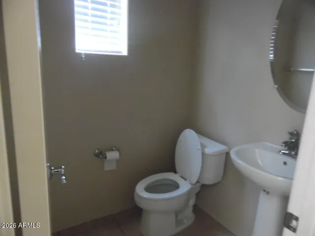 a white toilet sitting next to a white sink