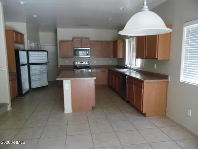 a kitchen with stainless steel appliances granite countertop a sink counter space cabinets and a window