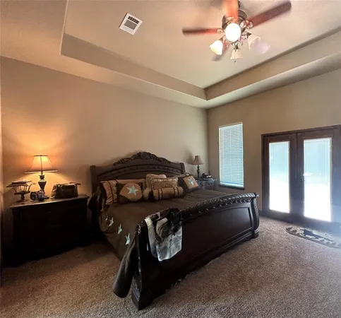 a bedroom with a bed and a lamp on desk