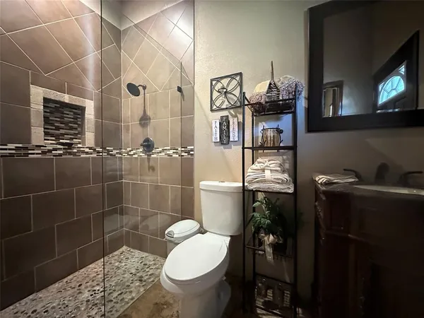 a bathroom with a sink toilet and shower