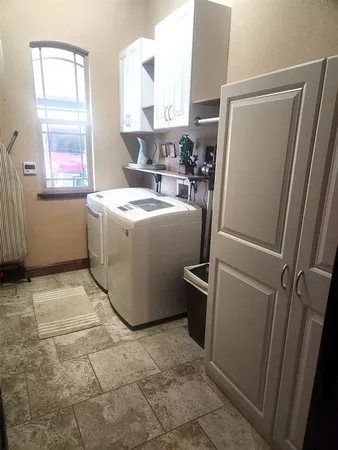a utility room with closet dryer and washer