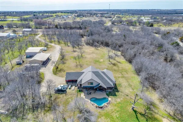 an aerial view of house with yard and ocean view