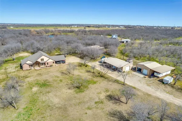 an aerial view of a house with a yard