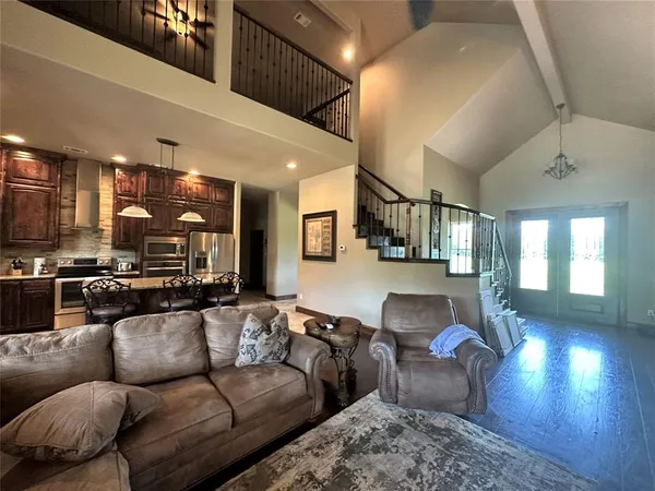 a living room with furniture and kitchen view