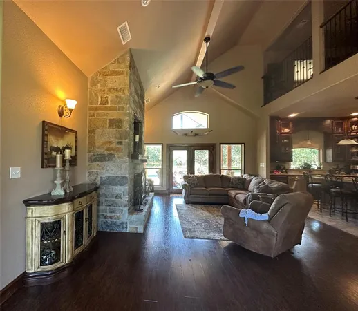 a living room with fireplace furniture and a wooden floor