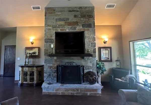 a living room with furniture a flat screen tv and a fireplace