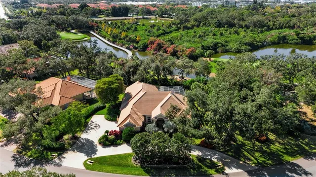 an aerial view of a house with a yard basket ball court and outdoor seating