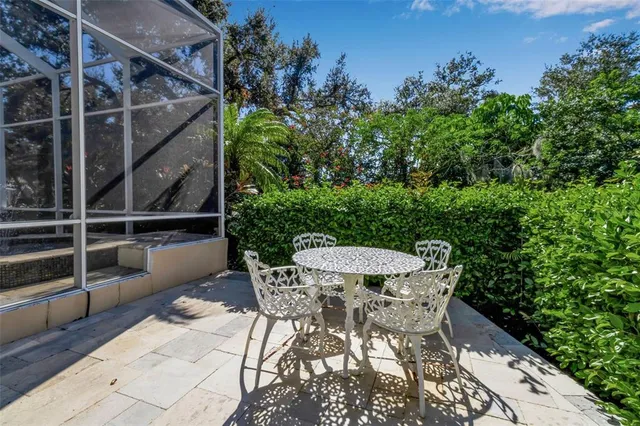 an aerial view of a house with garden space and trees all around