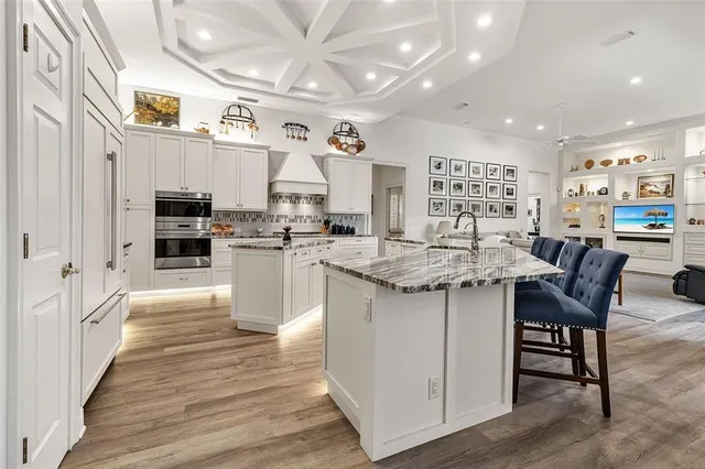 a kitchen with stainless steel appliances granite countertop a stove and cabinets