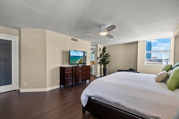 a bedroom with a bed and wooden floor