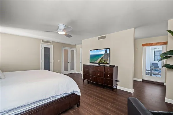 a bedroom with a bed and a flat screen tv