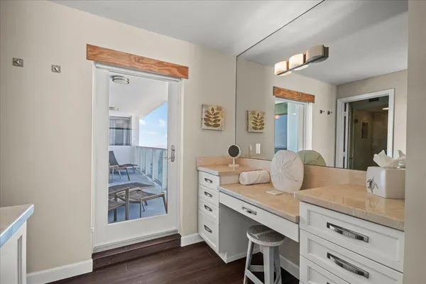 a spacious bathroom with a granite countertop sink and a mirror