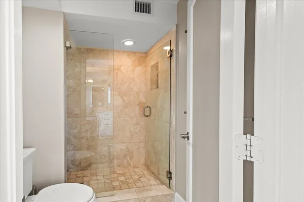 a bathroom with a shower and toilet