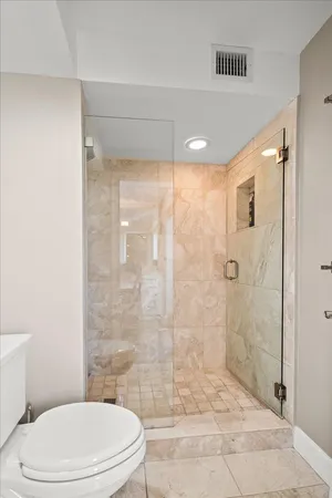 a bathroom with a toilet and shower