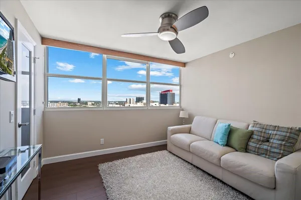 a living room with furniture and a ceiling fan