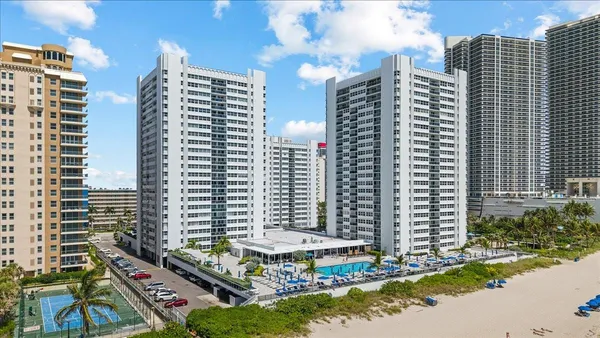 a view of a city with tall buildings and a big yard