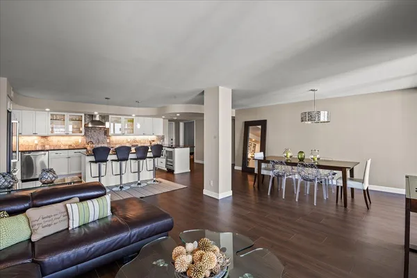a living room with furniture wooden floor and a table