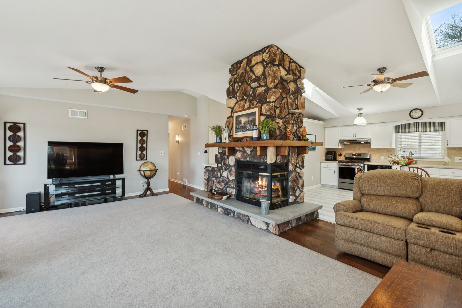 307 North Emerald Drive McHenry, IL 60051 - Photo 12 of 34 a living room with furniture a flat screen tv and a fireplace