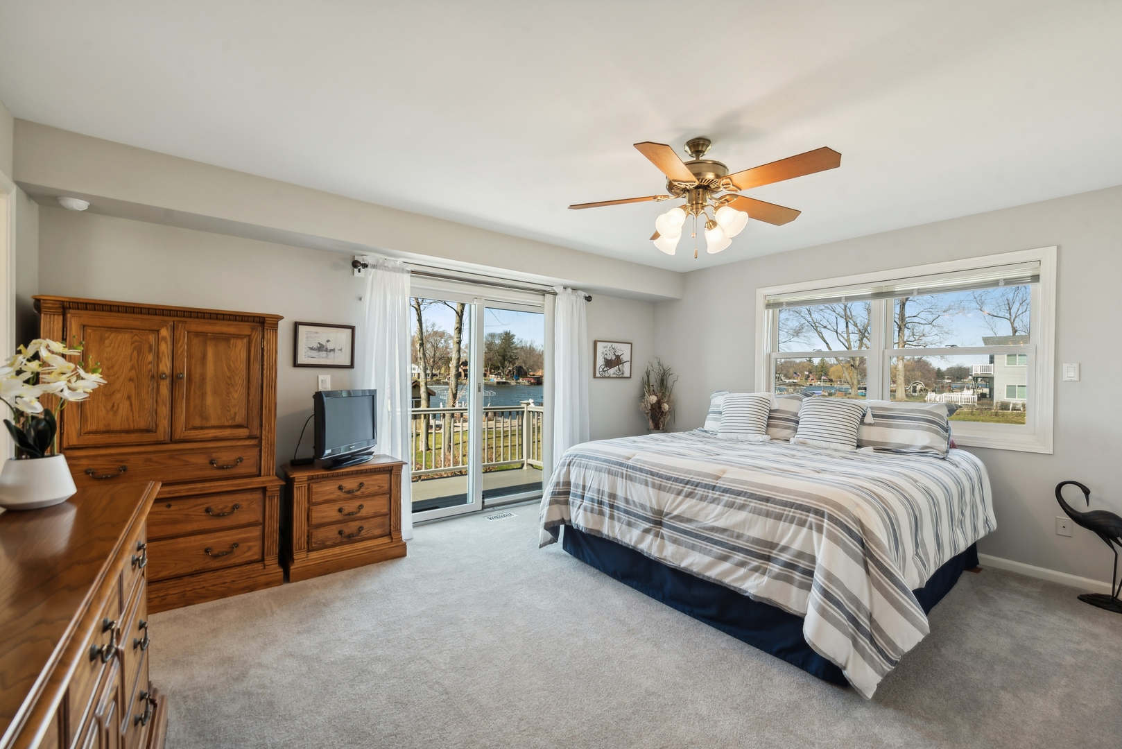 307 North Emerald Drive McHenry, IL 60051 - Photo 15 of 34 a spacious bedroom with a bed and a chandelier