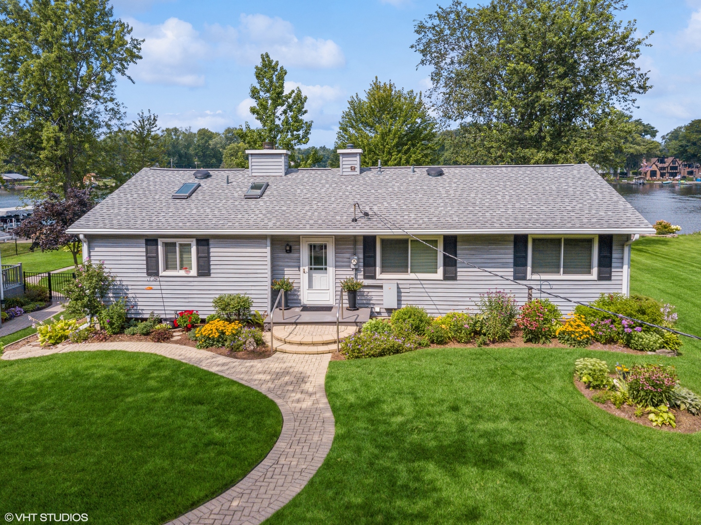 307 North Emerald Drive McHenry, IL 60051 - Photo 6 of 34 a front view of a house with a yard table and chairs