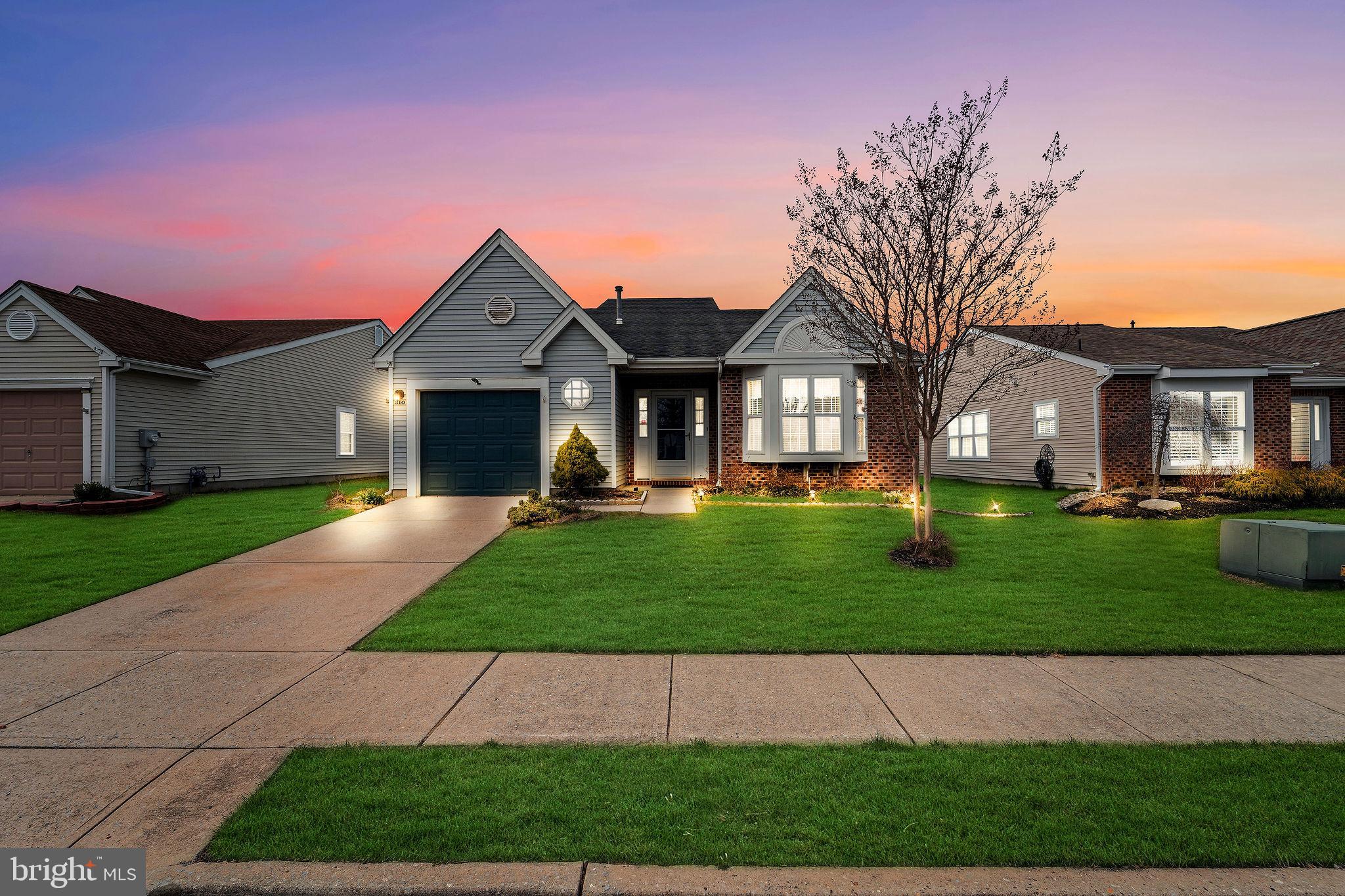 310 Moonseed Place Mount Laurel, NJ 08054 - Photo 1 of 27 a front view of a house with a yard and garage