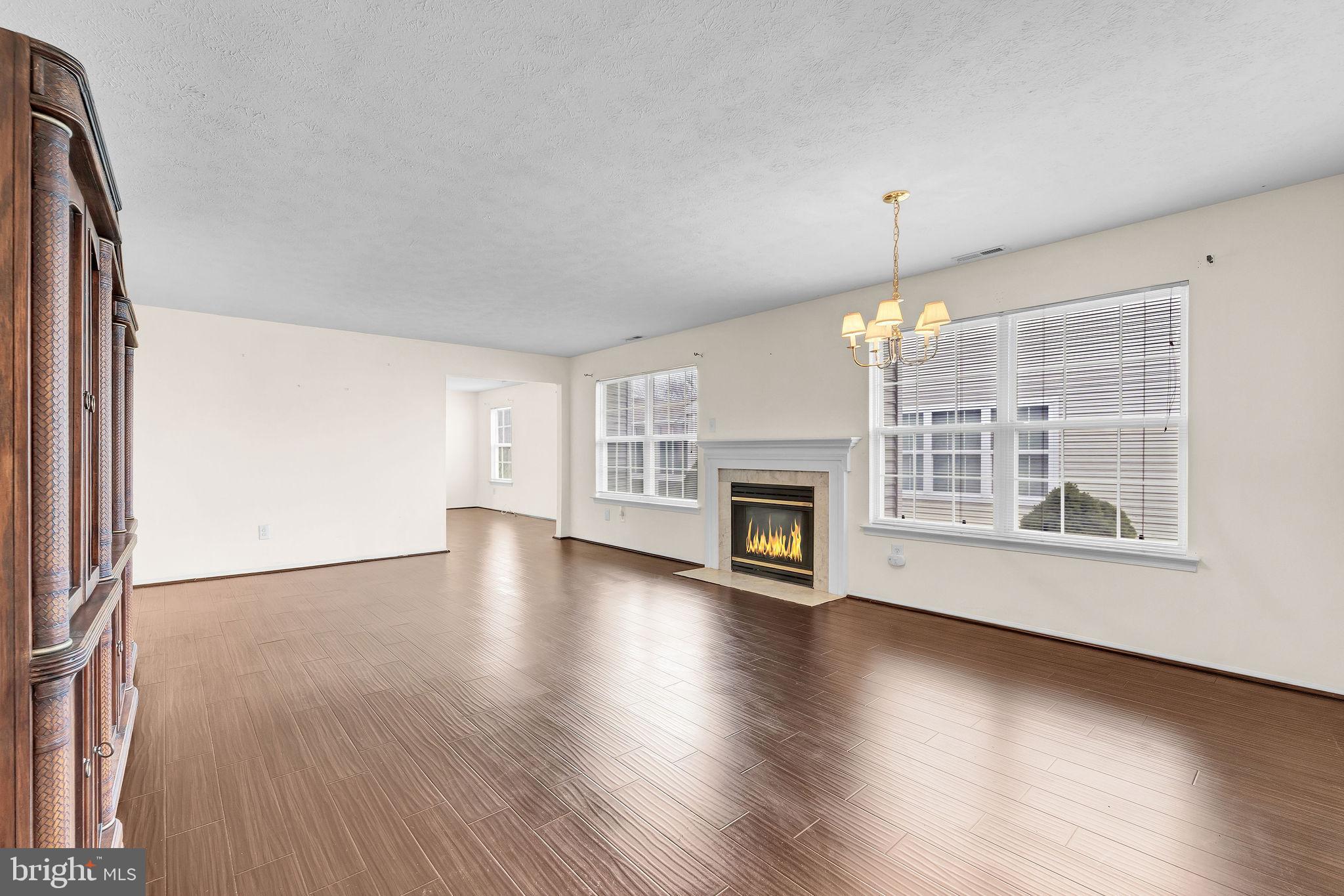 310 Moonseed Place Mount Laurel, NJ 08054 - Photo 11 of 27 an empty room with wooden floor fireplace and windows