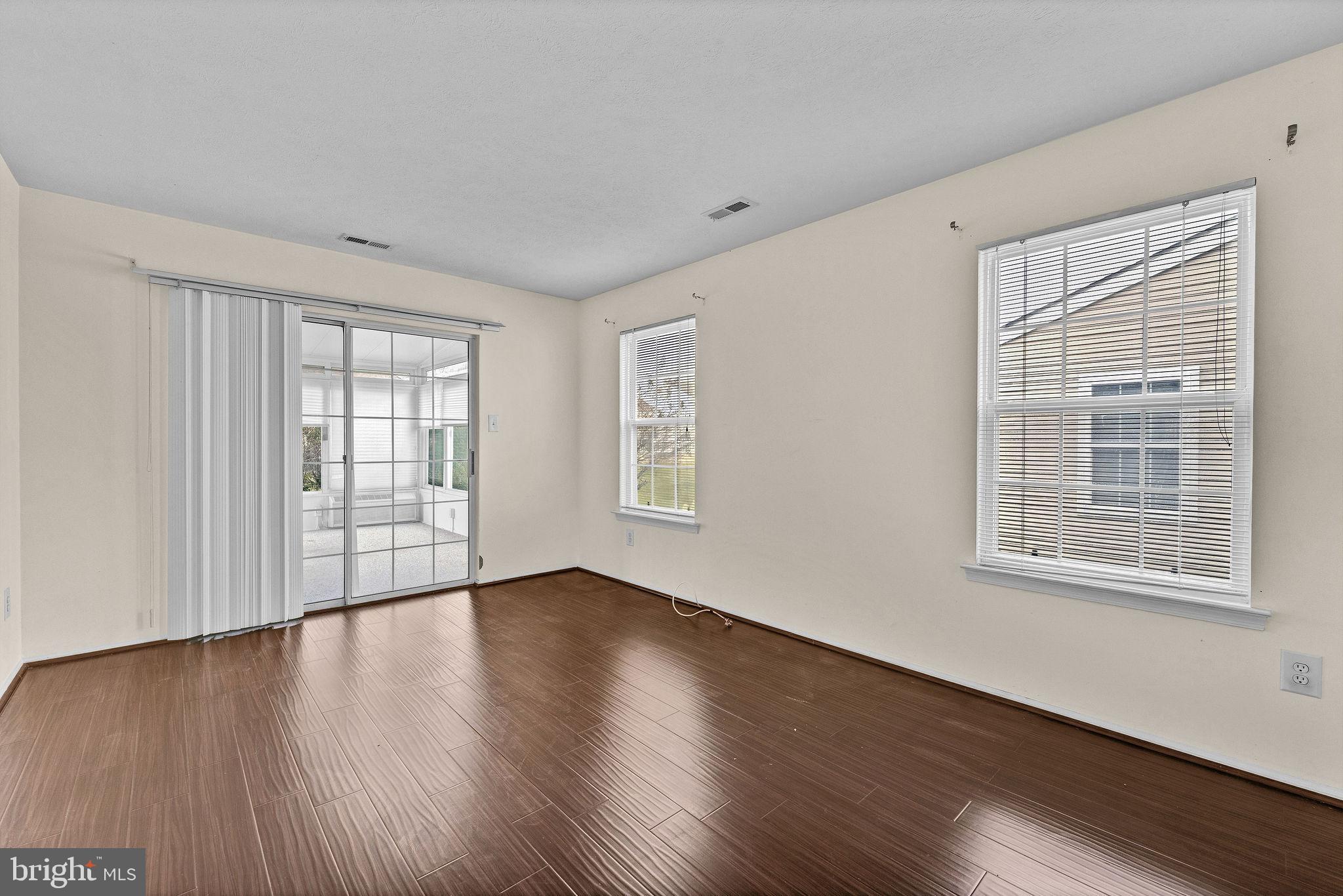 310 Moonseed Place Mount Laurel, NJ 08054 - Photo 14 of 27 a view of an empty room with wooden floor and a window