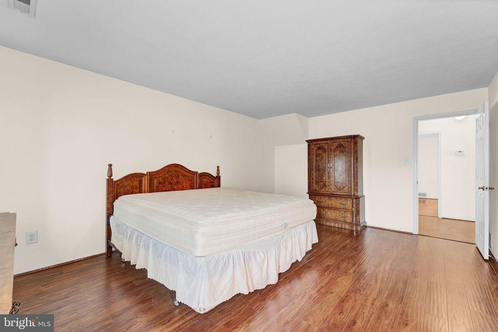 310 Moonseed Place Mount Laurel, NJ 08054 - Photo 16 of 27 a bedroom with a bed and wooden floor