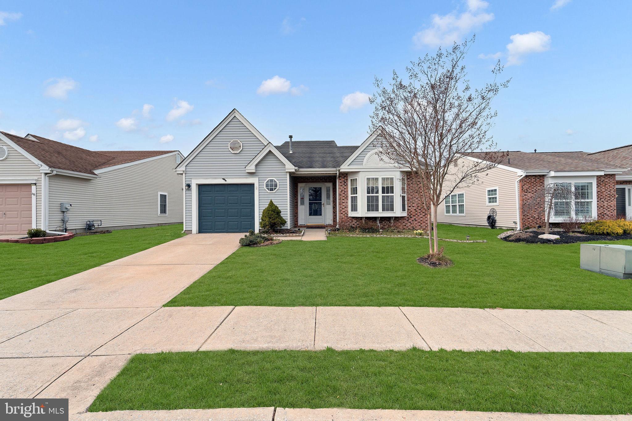 310 Moonseed Place Mount Laurel, NJ 08054 - Photo 2 of 27 a front view of a house with a garden and yard