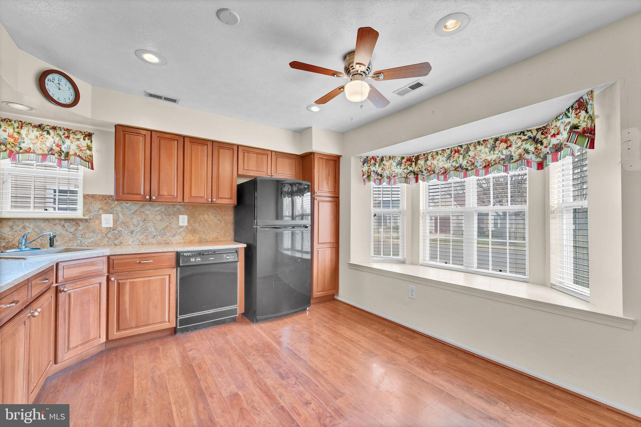 310 Moonseed Place Mount Laurel, NJ 08054 - Photo 6 of 27 a kitchen with stainless steel appliances granite countertop a refrigerator a sink dishwasher a stove and a refrigerator with wooden floor