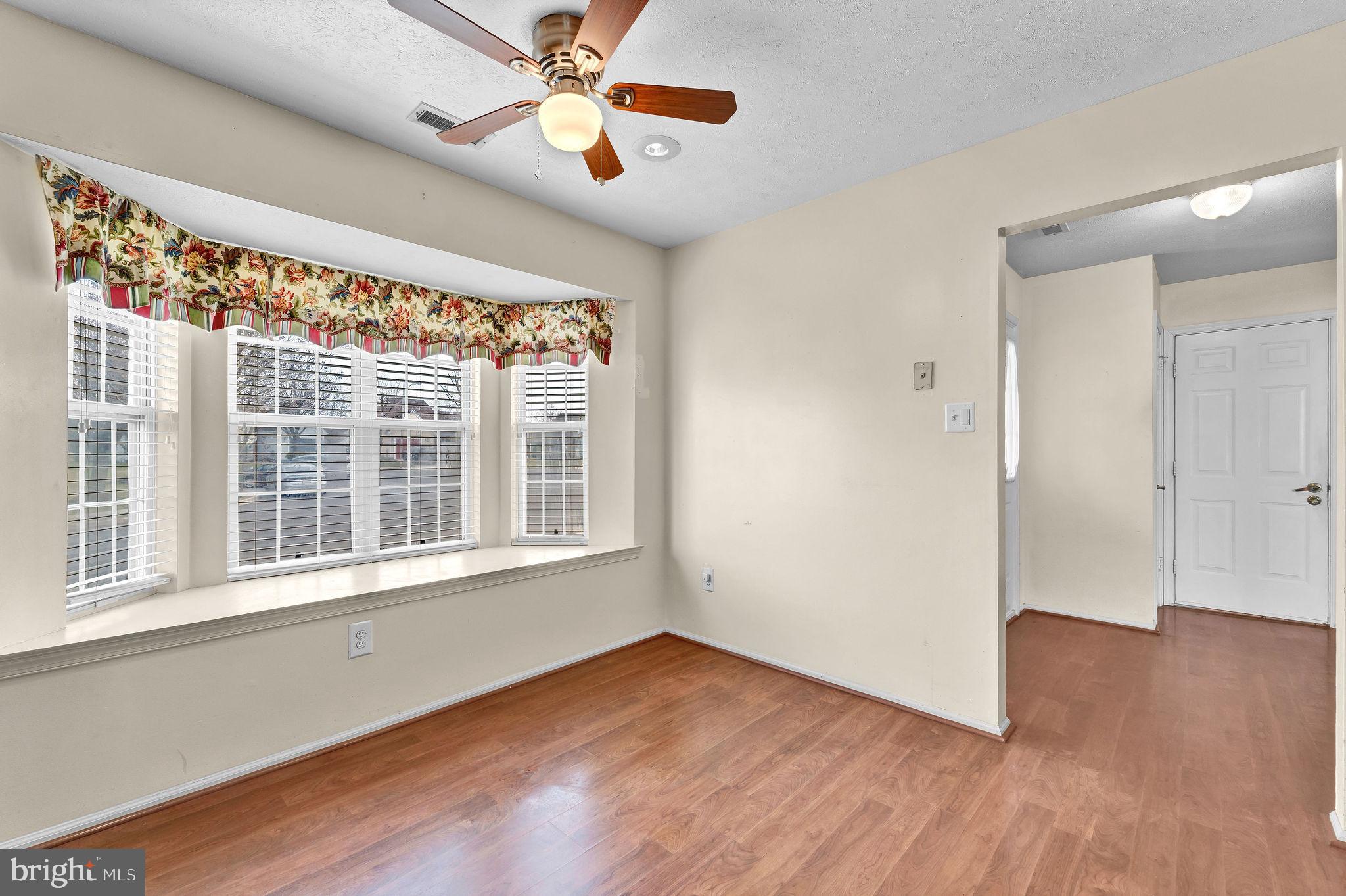 310 Moonseed Place Mount Laurel, NJ 08054 - Photo 8 of 27 a view of an empty room with wooden floor and a window