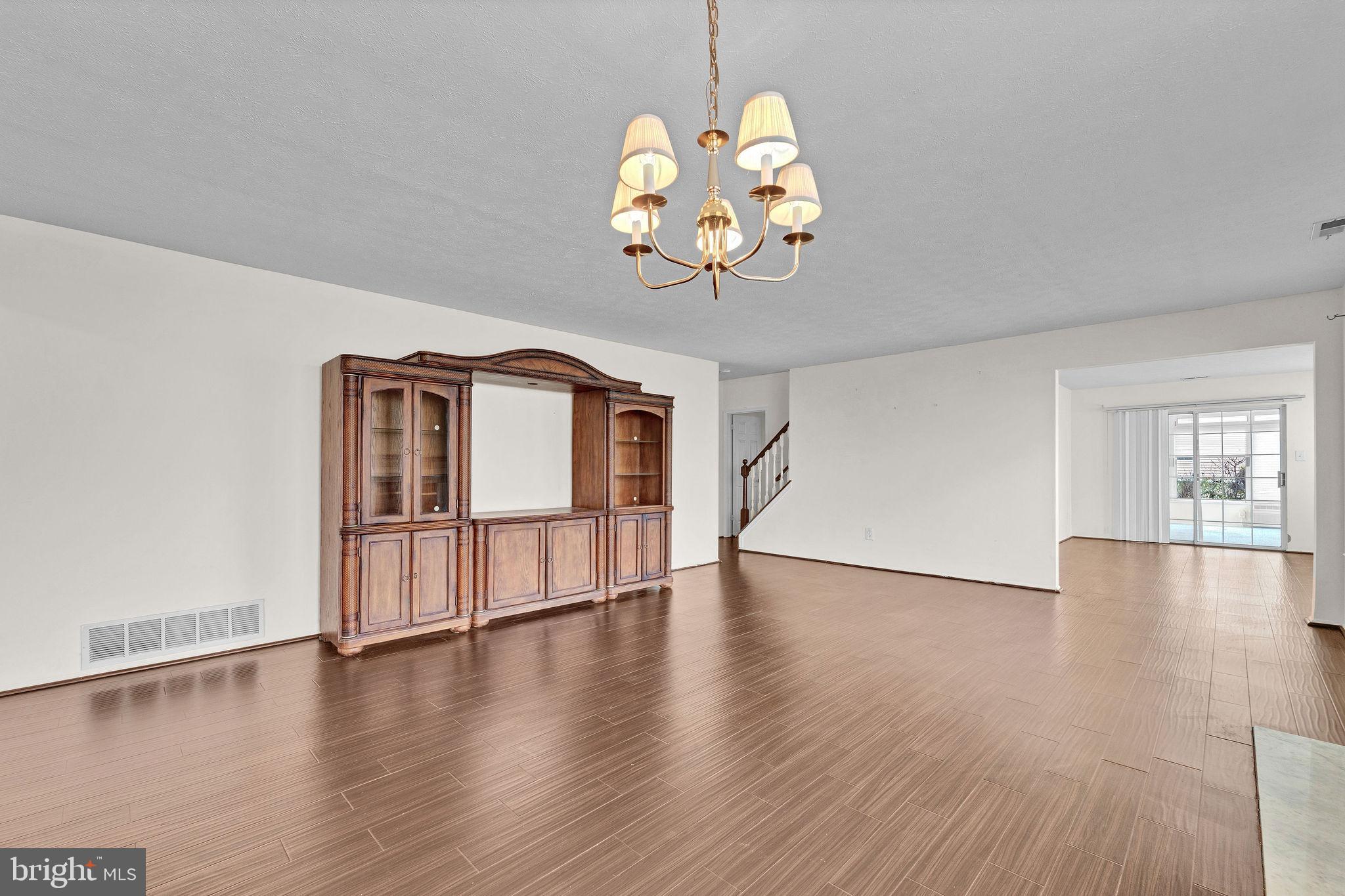 310 Moonseed Place Mount Laurel, NJ 08054 - Photo 9 of 27 a view of an empty room with wooden floor and a window