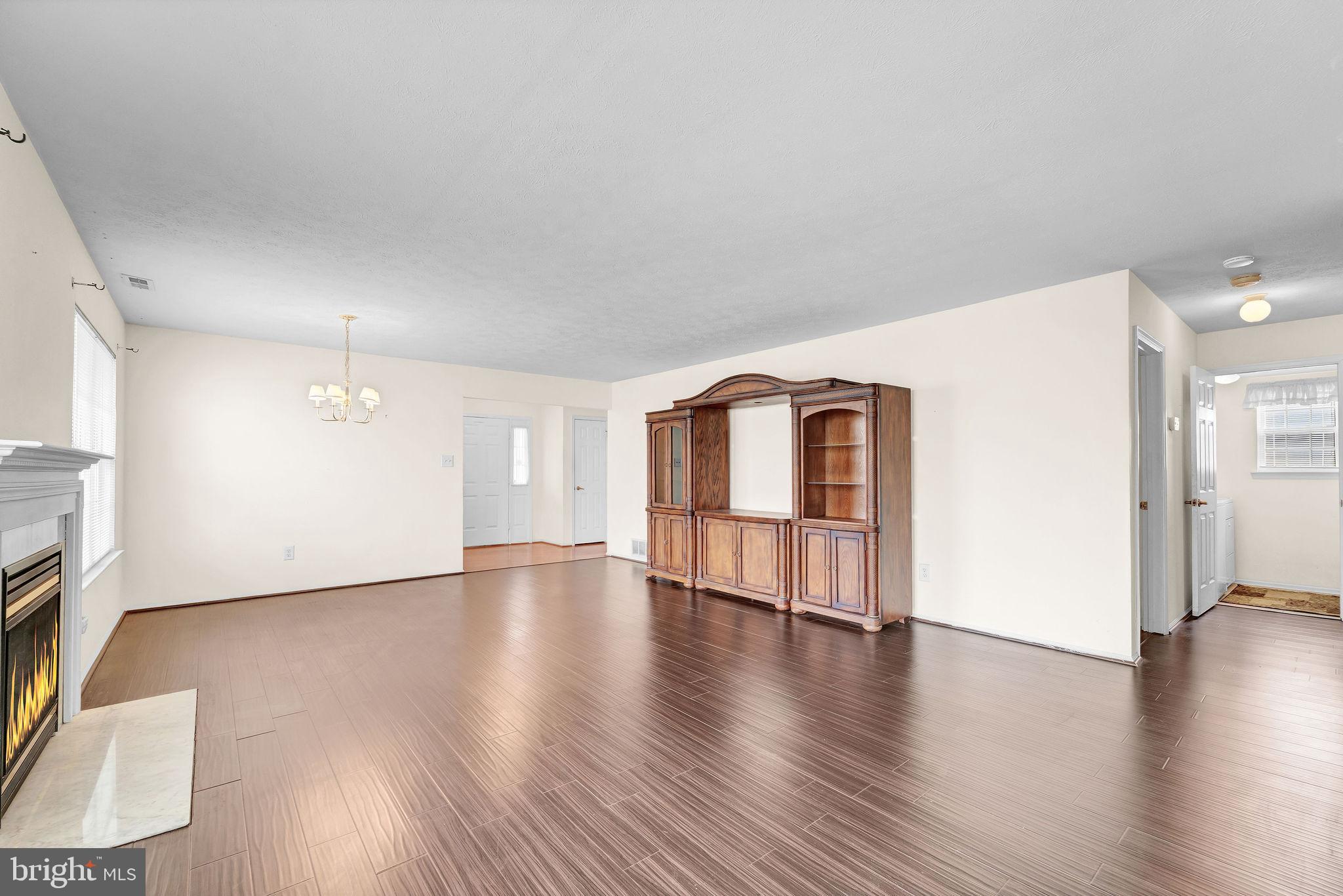 310 Moonseed Place Mount Laurel, NJ 08054 - Photo 10 of 27 a view of an empty room with wooden floor and a window