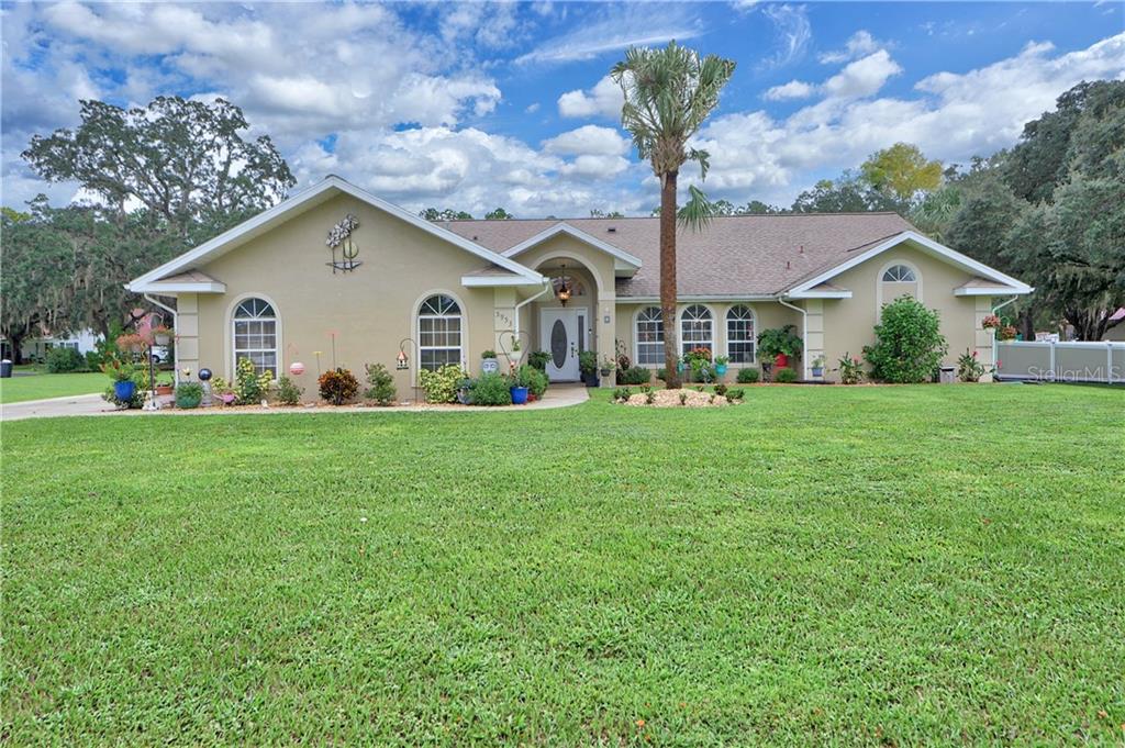 5953 Northeast 62nd Court Road Silver Springs, FL 34488 - Photo 1 of 1 a front view of a house with garden
