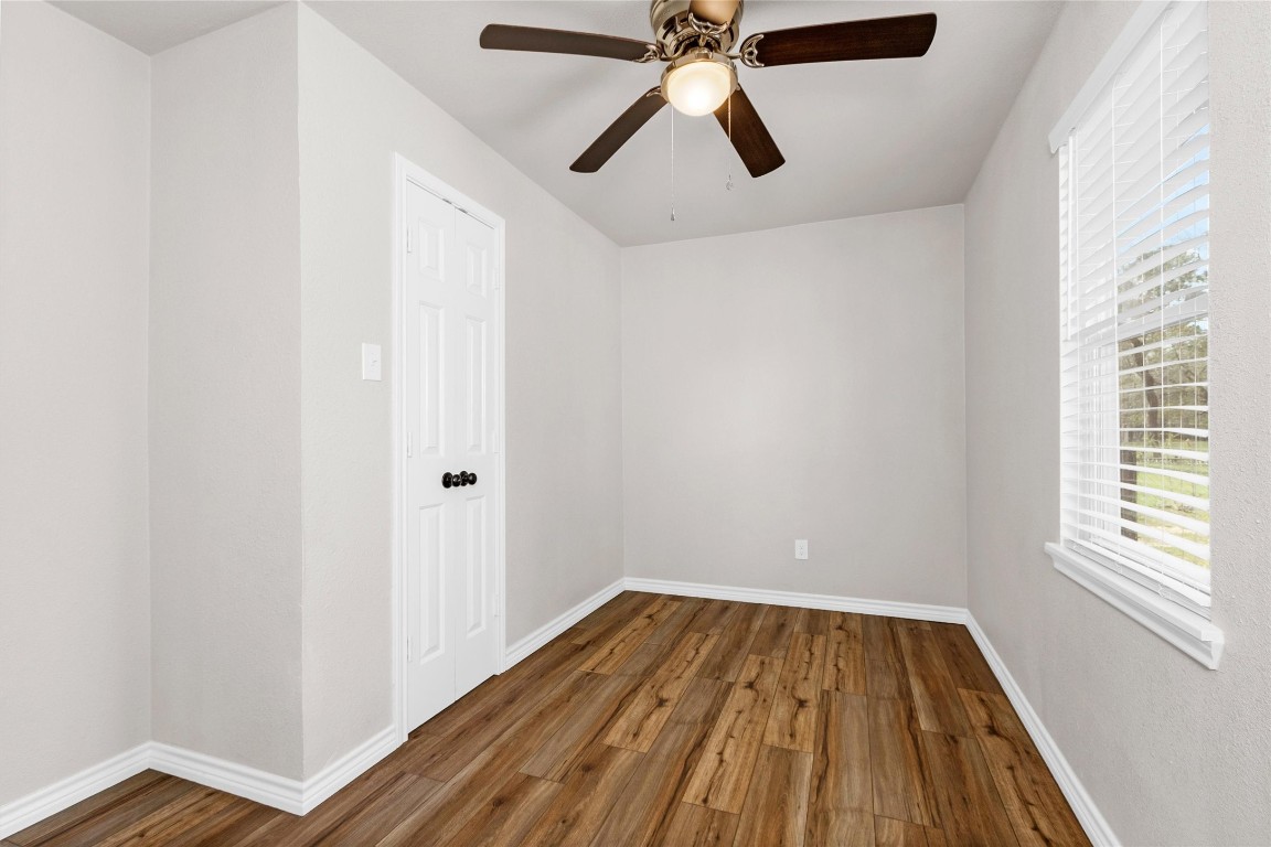 338 South Walker Road Conroe, TX 77306 - Photo 12 of 25 a view of a hallway with wooden floor and chandelier