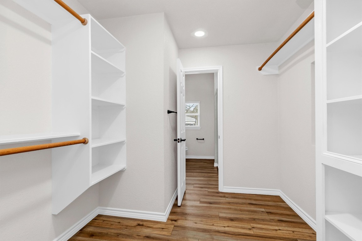 338 South Walker Road Conroe, TX 77306 - Photo 17 of 25 a view of hallway with stairs and wooden floor