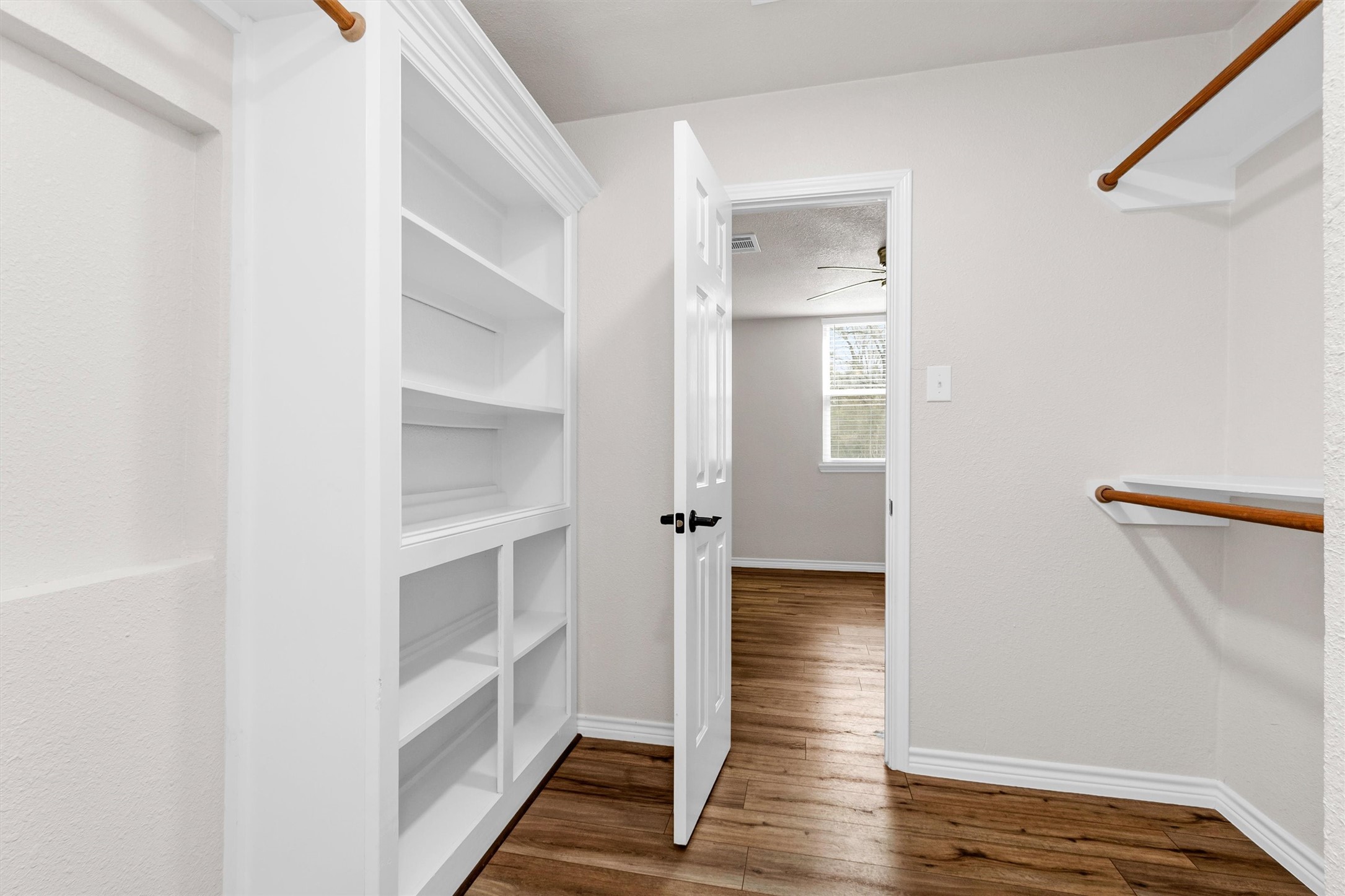 338 South Walker Road Conroe, TX 77306 - Photo 18 of 25 a view of a hallway with wooden floor and closet