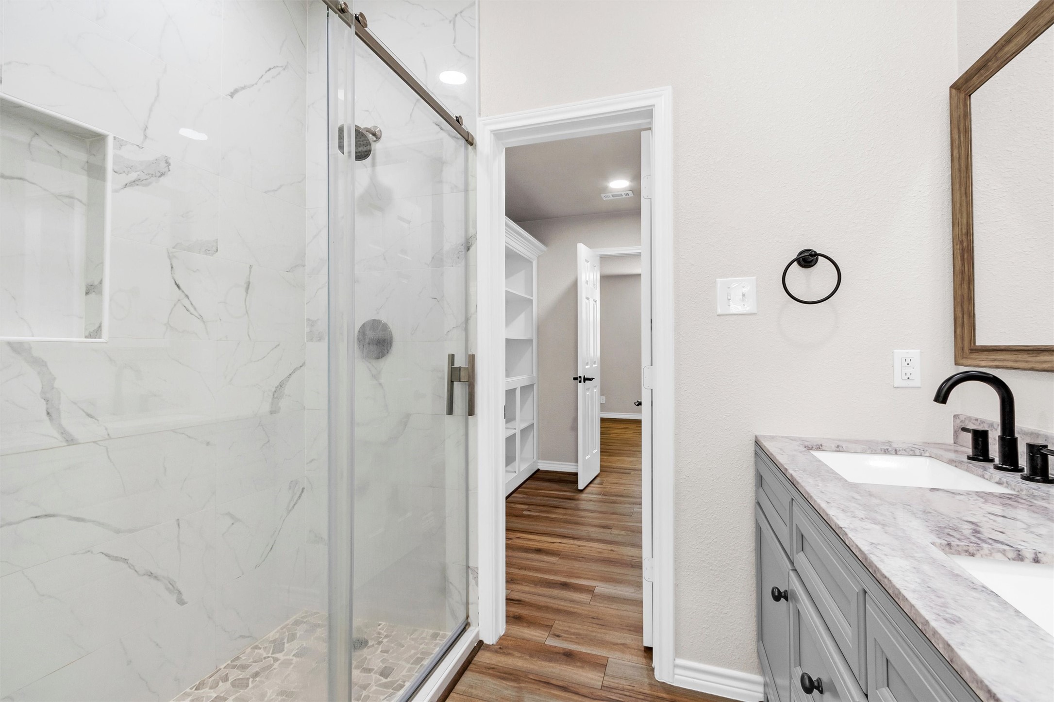 338 South Walker Road Conroe, TX 77306 - Photo 20 of 25 a bathroom with a granite countertop shower sink and mirror