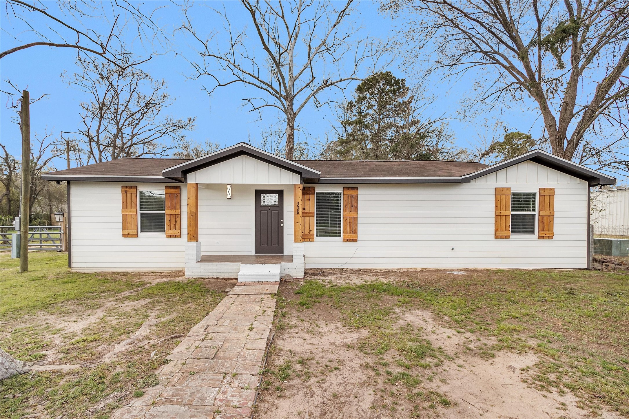 338 South Walker Road Conroe, TX 77306 - Photo 2 of 25 a front view of a house with a yard and garage