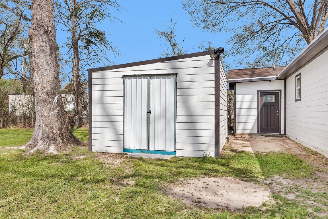 338 South Walker Road Conroe, TX 77306 - Photo 21 of 25 a front view of a house with garden