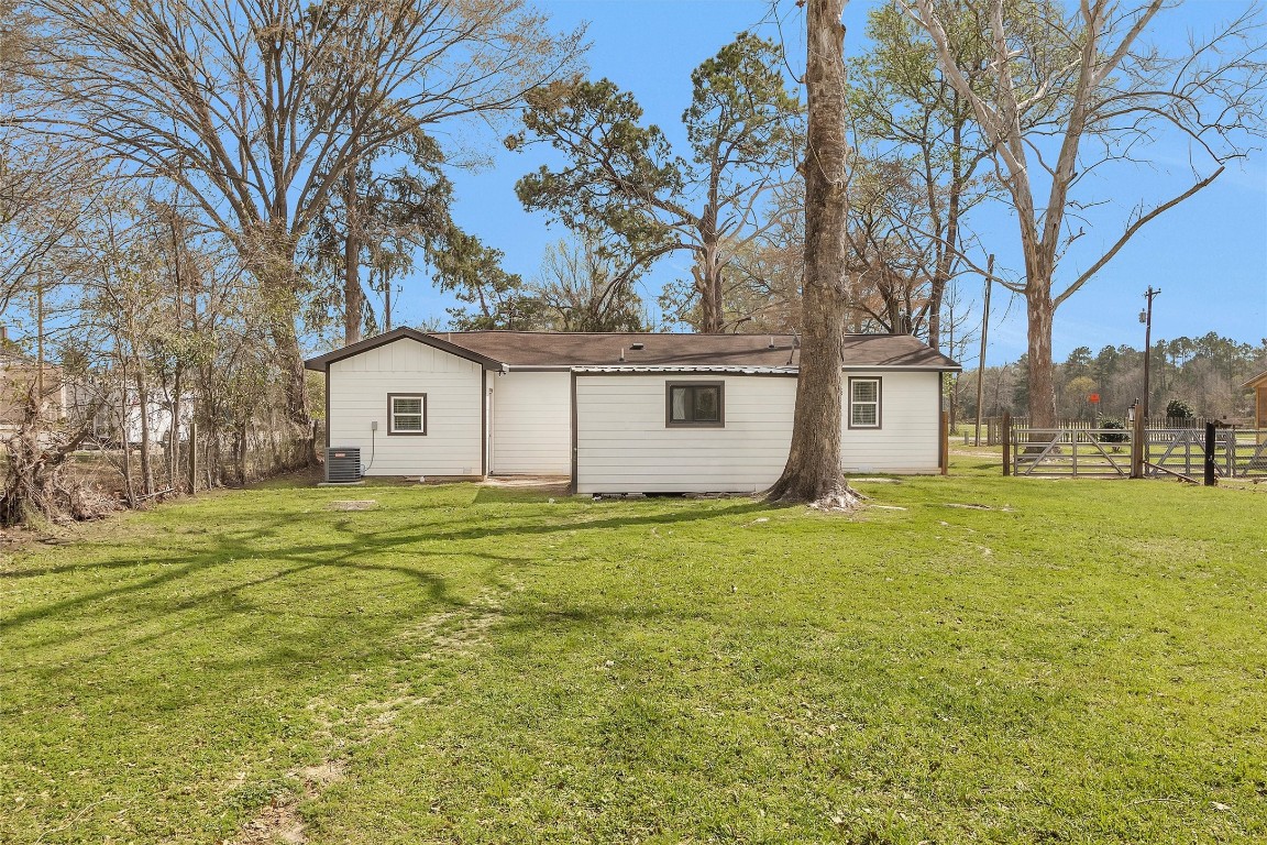 338 South Walker Road Conroe, TX 77306 - Photo 24 of 25 a view of a house with a backyard