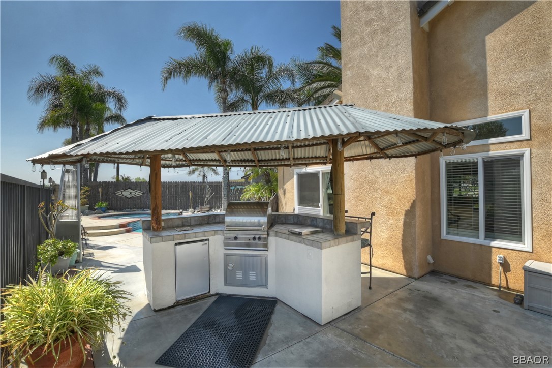 2201 Wagon Train Street Corona, CA 92878 - Photo 20 of 24 a view of a patio with table and chairs under an umbrella