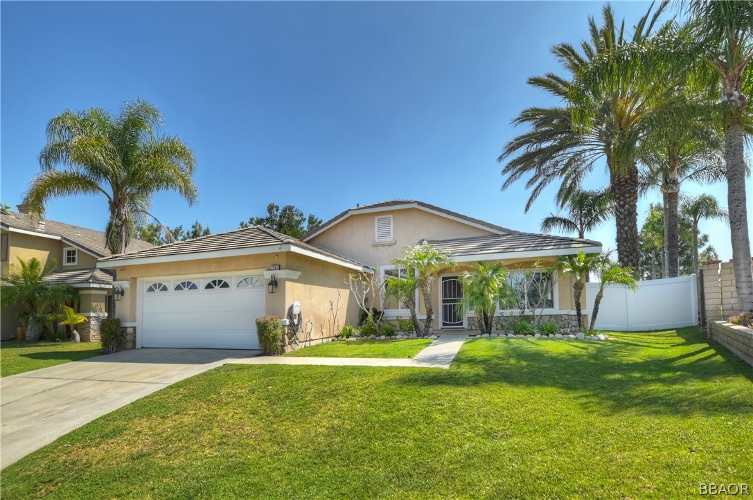 2201 Wagon Train Street Corona, CA 92878 - Photo 2 of 24 a front view of a house with garden and porch