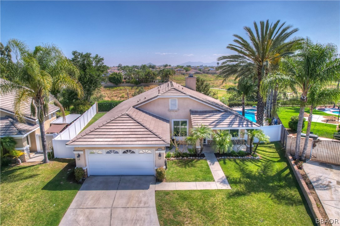 2201 Wagon Train Street Corona, CA 92878 - Photo 23 of 24 a view of a house with a small yard plants and a large tree
