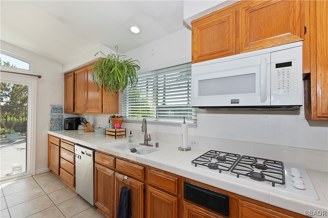 2201 Wagon Train Street Corona, CA 92878 - Photo 9 of 24 a kitchen with stainless steel appliances a sink stove and cabinets