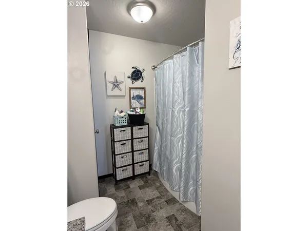 a bathroom with a toilet and a shower