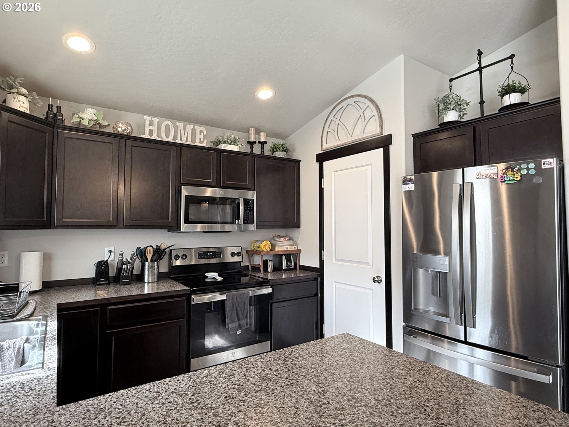 472 Cardinal Place Umatilla, OR 97882 - Photo 4 of 28 a kitchen with stainless steel appliances granite countertop a refrigerator a stove a sink and a microwave