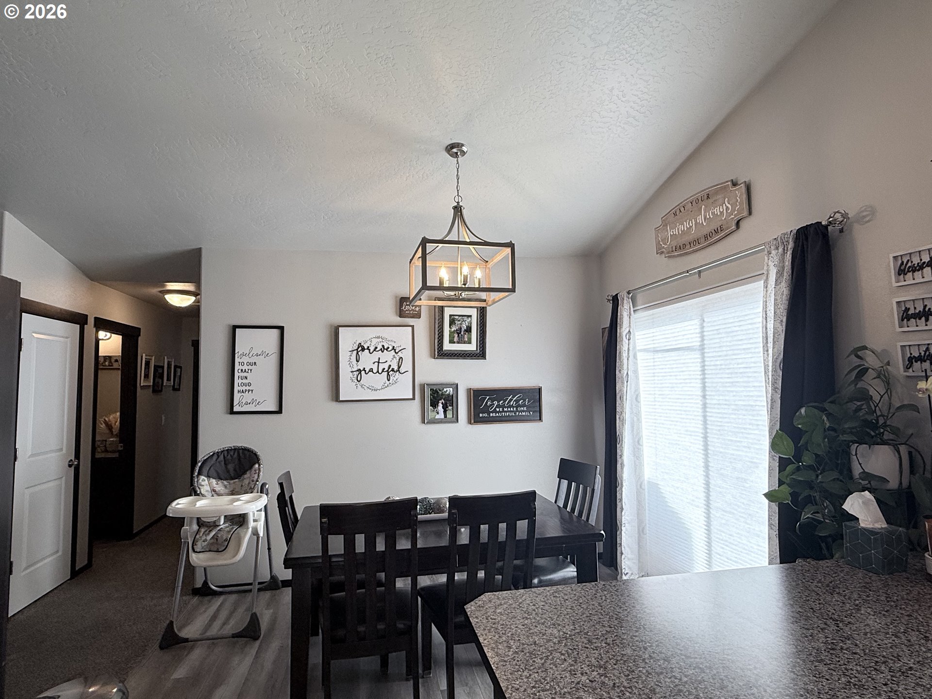 472 Cardinal Place Umatilla, OR 97882 - Photo 5 of 28 a dining room with wooden floor a chandelier a wooden table and chairs